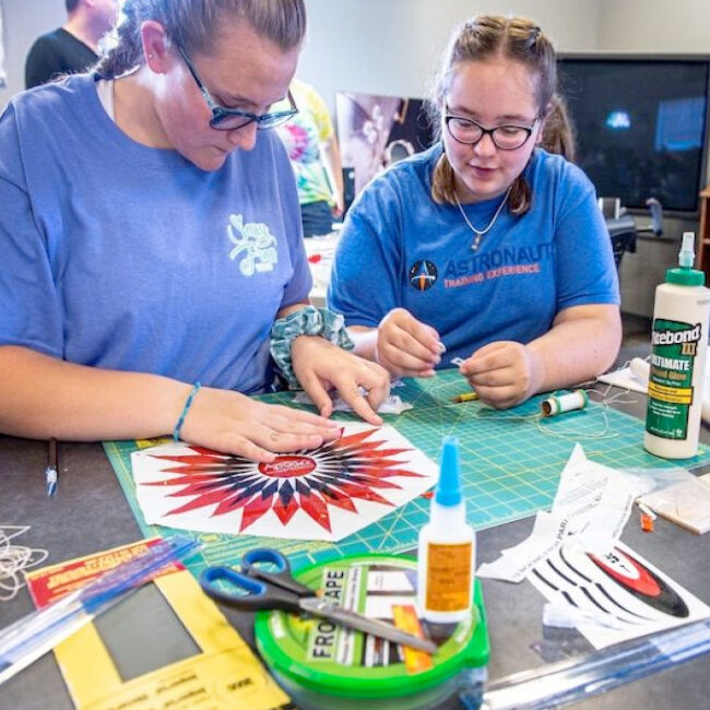 K-12 education and outreach; student doing calculated arts and crafts; student and teacher doing science